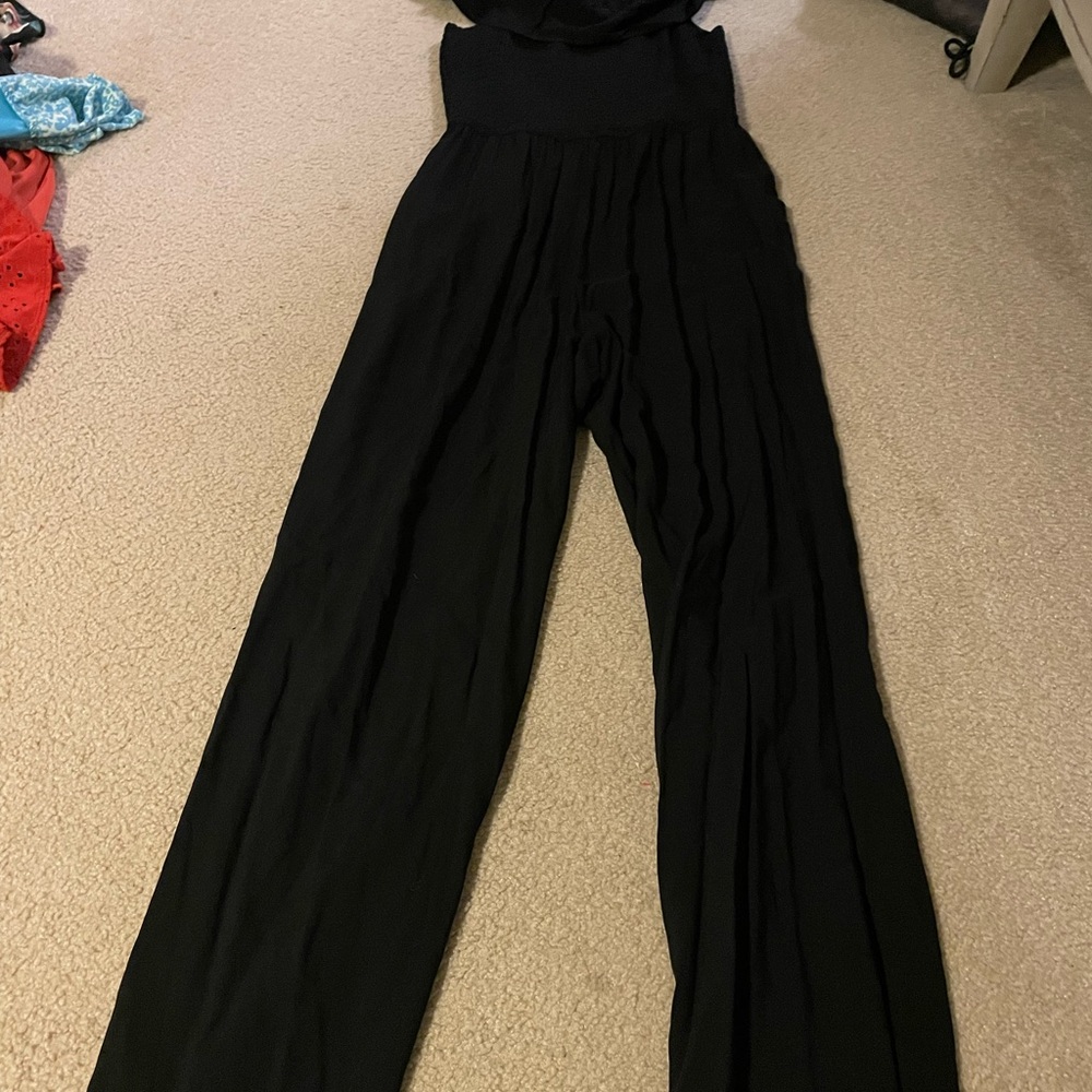 Juniors black jumpsuit- off the shoulder. Flowing relaxed leg fit.